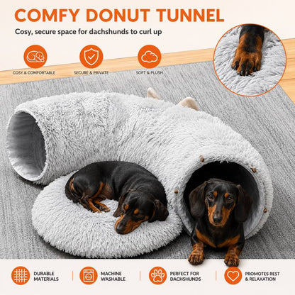 Dachshund relaxing inside the plush tunnel bed